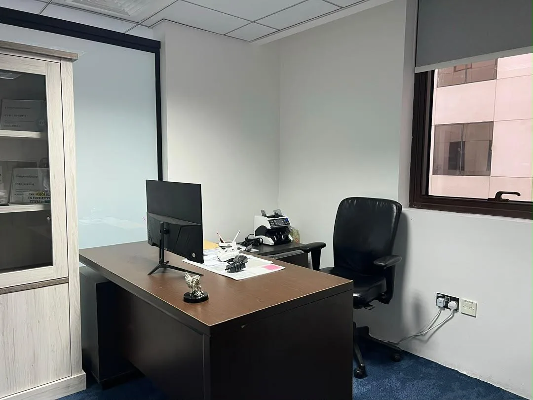 A private office at CNK Real Estate with a desk and window